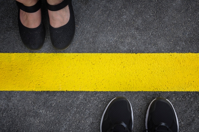 Two people divided by a yellow line